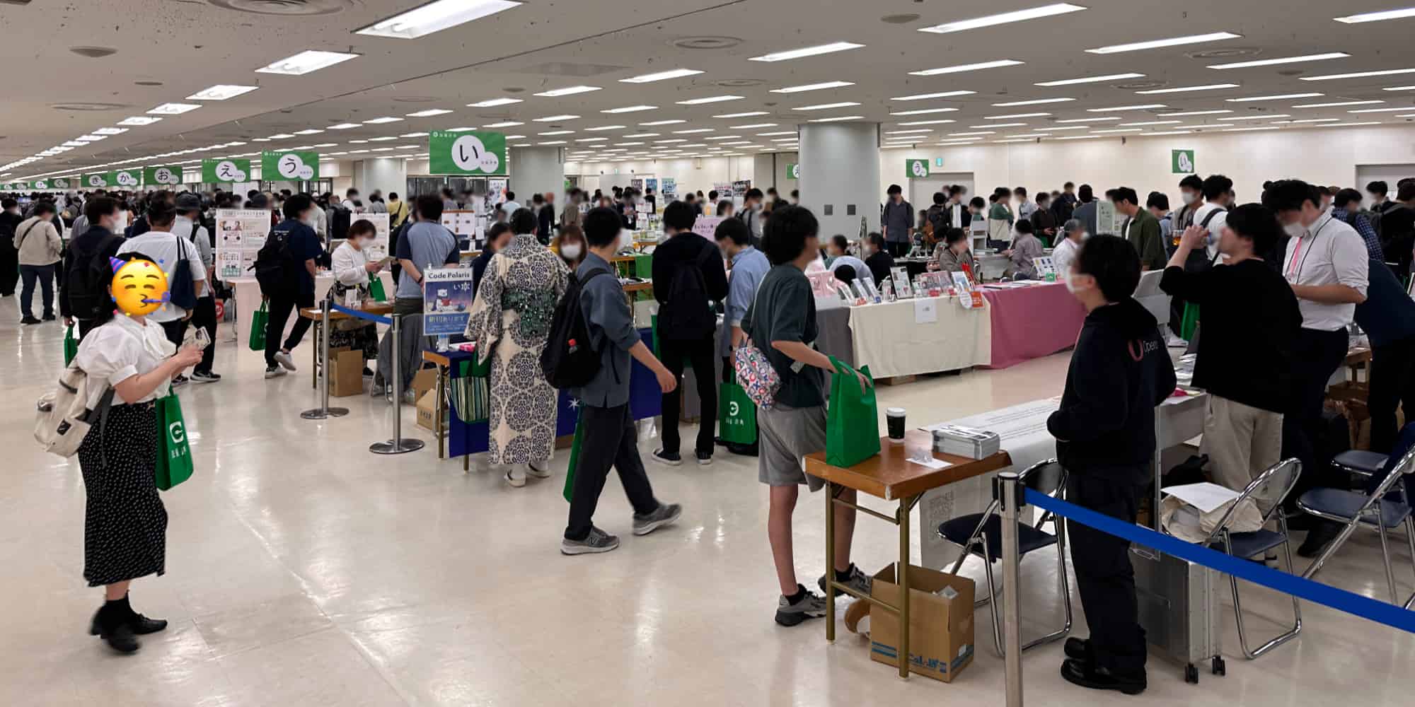 TechBookFest 14 hall with attendees at booths, engaged in reading, talking, and exploring